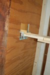 With an 80+ year old home, surprises abound.  A false bulkhead wall put up sometime in the past century.  The track pierces the plywood to connect the two segments.

Magnetic latches are used for alignment and power transfer on both ends of the liftout.