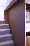 The stud wall along the stairwell was skinned with tempered hardboard to provide a formal entrance to the layout room.