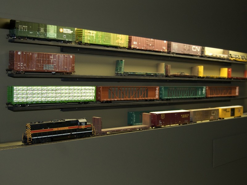 Excess rolling stock is stored on custom built shelving to allow cars to easily be swapped without overloading the layout.