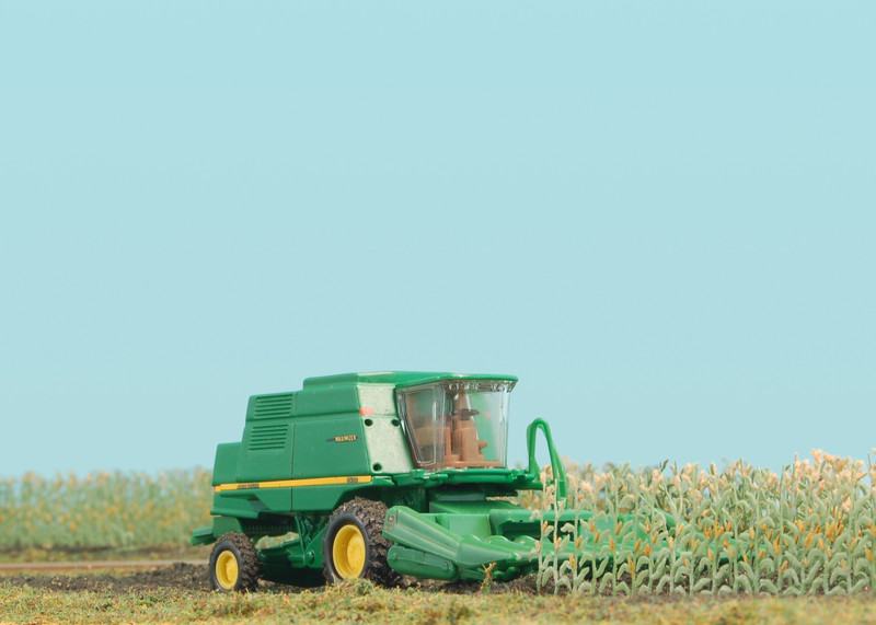 Busch's corn stalks and a ERTL John Deere Combine are featured in this cornfield scene between Beisser Lumber and Geneser Feed.